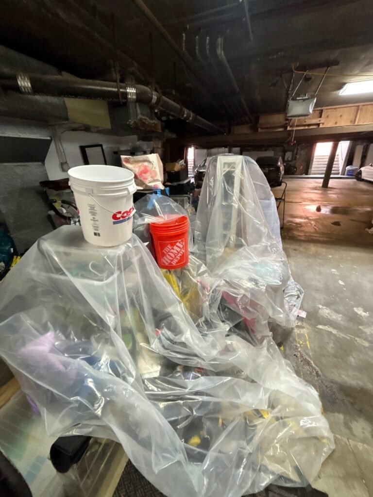 Household contents wrapped in plastic sheeting in a garage in the East Bay