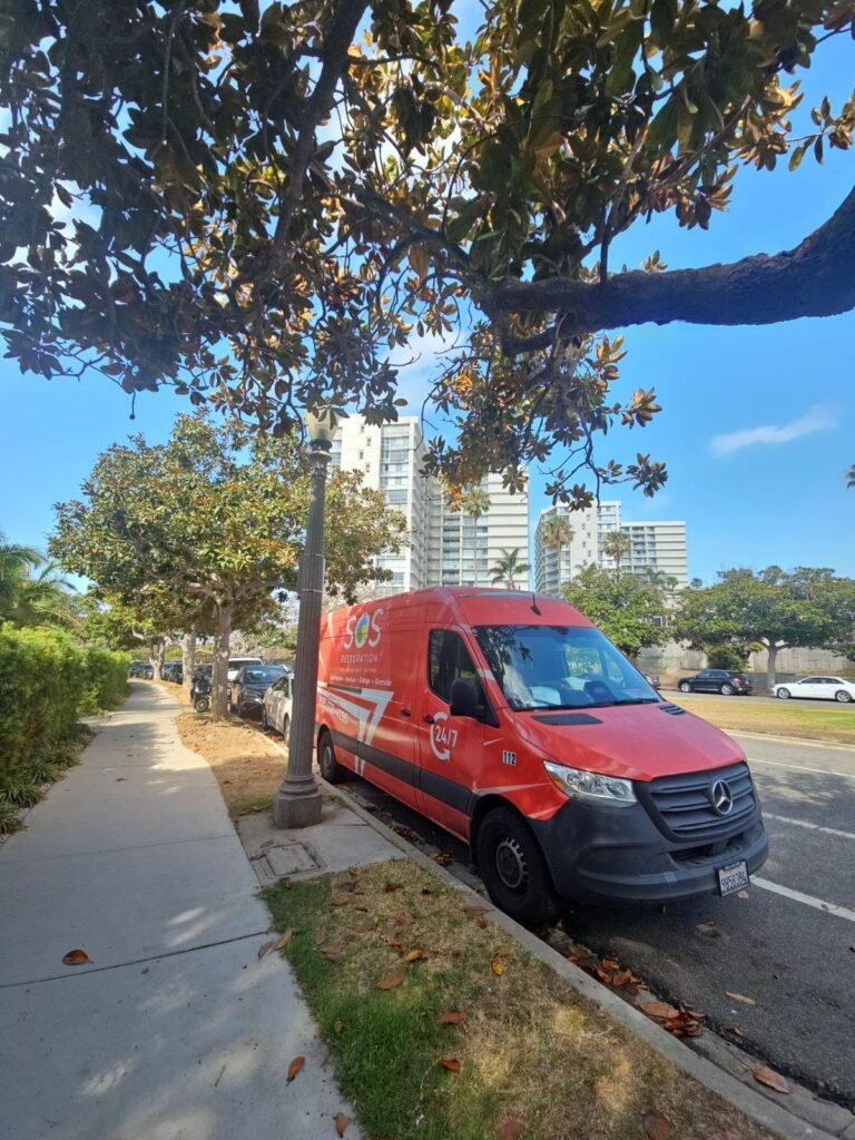 The SOS van parked by a park across from apartment towers in the East Bay